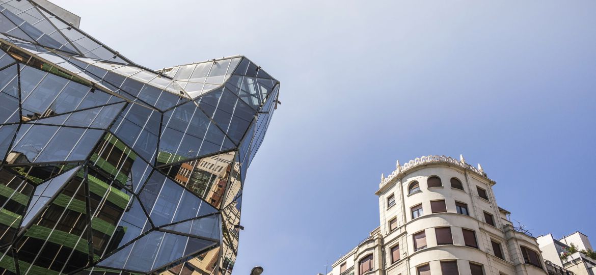 Contrast of architectural styles under a clear blue sky