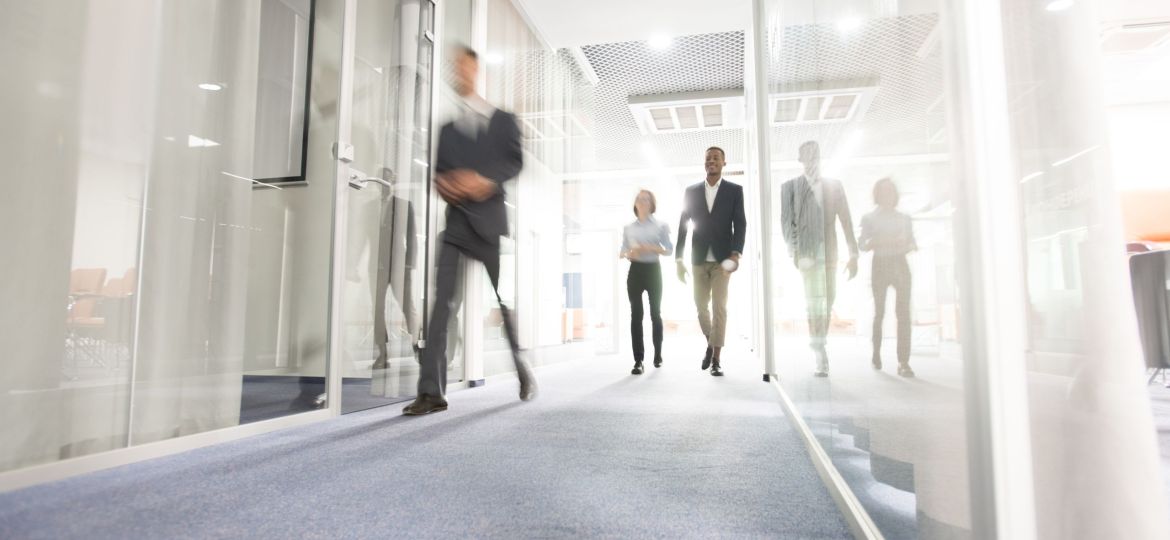 Business people walking in office corridor